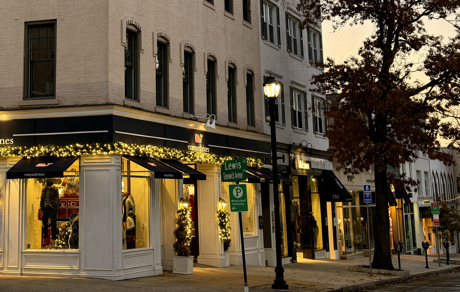 Greenwich Avenue retail storefronts at dusk